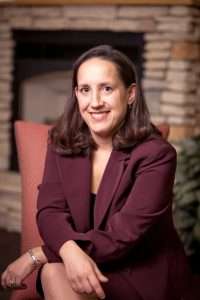 Attorney Virginia "Ginny" Barron, criminal defense and forensic law specialist in Minnesota, seated in a professional setting.